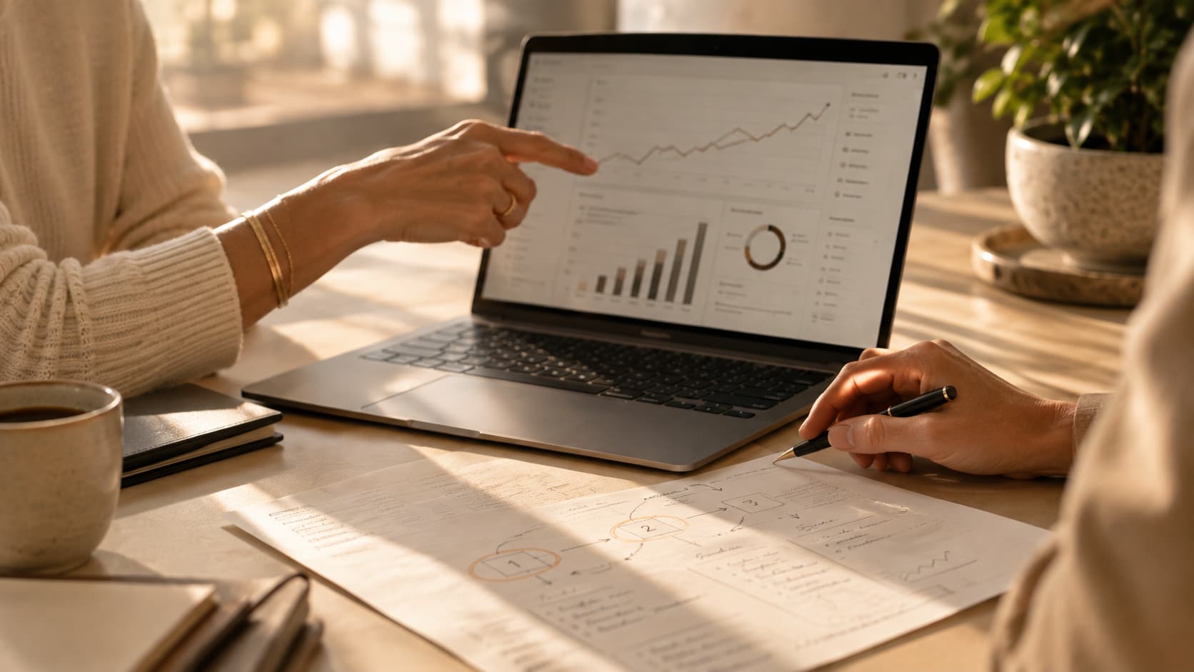 Two people reviewing a customised growth game plan on a laptop